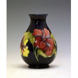 William Moorcroft 'Hibiscus' pattern vase, of bulbous form with tube-lined decoration on a dark blue