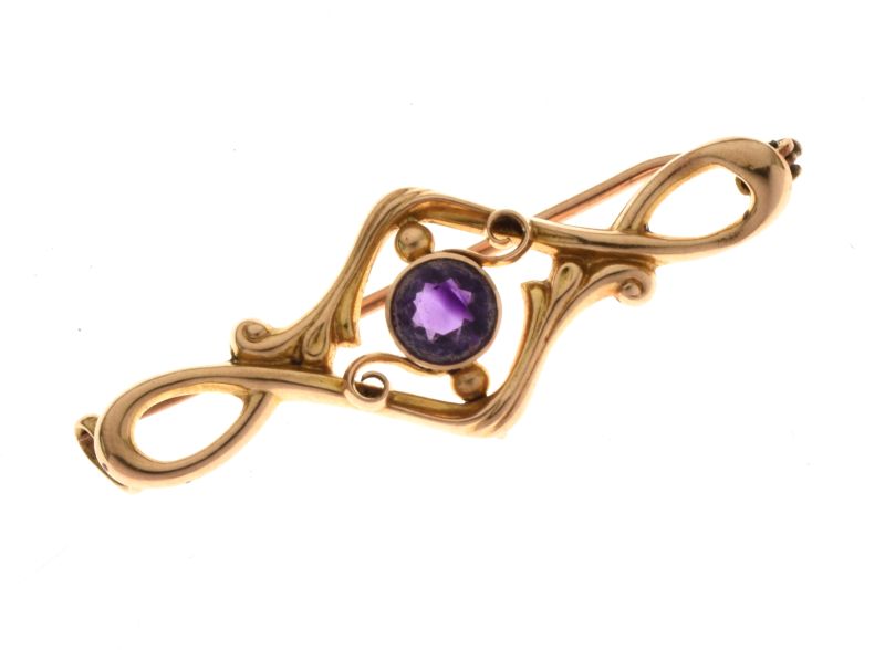 Amethyst brooch, the round cut stone to a sinuous leaf frame tagged '15ct', 4cm long, 2.4g gross