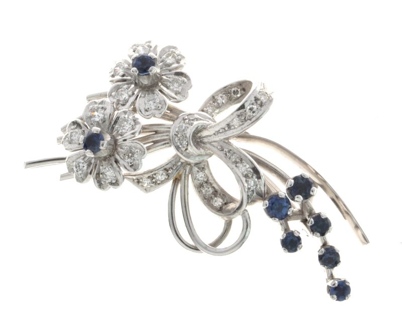 Diamond and sapphire spray brooch, in unmarked white metal, set throughout with twenty-nine small