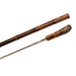 Antique sword-stick in a bamboo sheath, the hilt formed partly from the bamboo root with straight