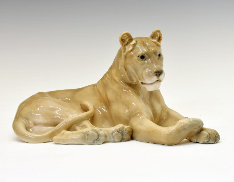 Royal Copenhagen porcelain figure of a lioness, modelled in recumbent pose, with printed and painted