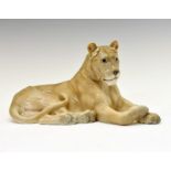 Royal Copenhagen porcelain figure of a lioness, modelled in recumbent pose, with printed and painted