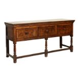 Late George III oak dresser base, the planked moulded rectangular top over three crossbanded