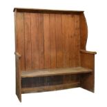 19th Century pine wing-back settle, with ten-plank back between shaped wings and plain end