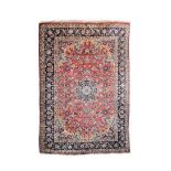 Middle Eastern (South Persian) wool carpet, the madder rose field with central floral and foliate