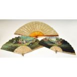 Two late 19th/early 20th Century watercolour-decorated silk fans, the first depicting Cupid and a