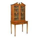Early 20th Century inlaid satinwood cabinet on stand, the upper stage with architectural 'broken'