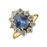 Sapphire and diamond 18ct gold cluster ring, the oval cut stone measuring approximately 9.1mm x