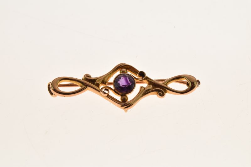 Amethyst brooch, the round cut stone to a sinuous leaf frame tagged '15ct', 4cm long, 2.4g gross - Image 2 of 6