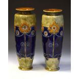 Pair of Royal Doulton stoneware vases having typical Art Nouveau floral and foliate decoration,