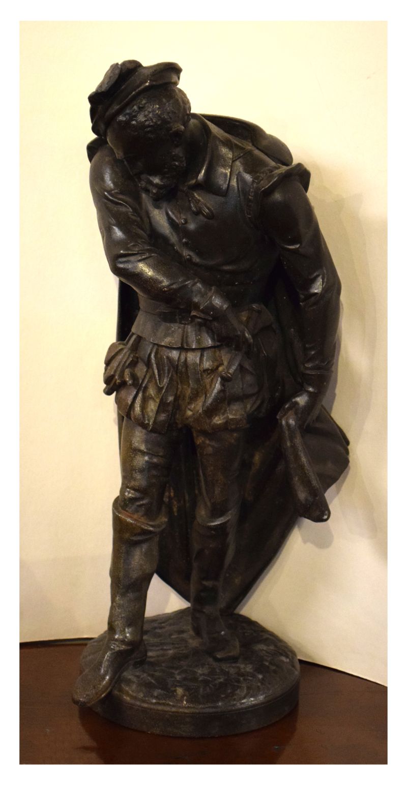 Late 19th Century bronzed iron figure of a gentleman drawing his sword, 45cm high