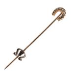 Unmarked yellow metal tie or stickpin set eleven small diamonds in a horseshoe motif, 2.5g gross