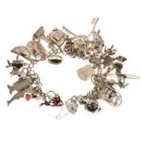 White metal curb link charm bracelet with padlock stamped Sterling silver and approximately thirty-