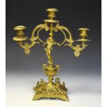 Late 19th Century brass two-branch candelabra with figural stem on pierced square base, 35cm high
