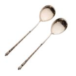 Pair of white metal Russian spoons with spiral twist handles, the reverse of the bowls having