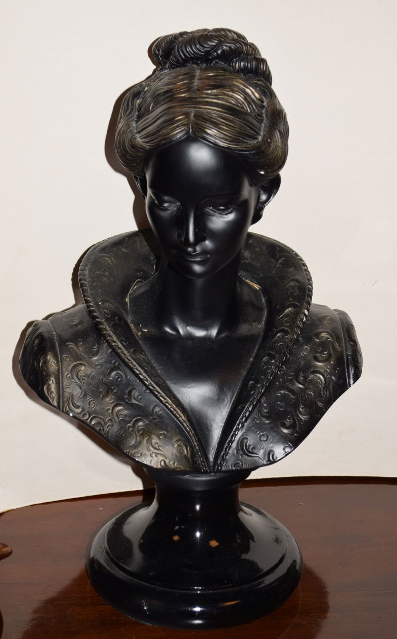 Early 20th Century composition library bust of a maiden with parted hair on black-painted