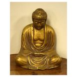 Cast metal gilt painted figure of a seated Buddha, 26.5cm high