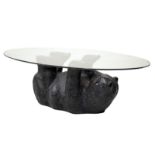 Contemporary oval glass top coffee table supported by an inverted resin bear, 112cm x 81cm