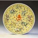 Chinese porcelain circular bowl decorated with dragons on a yellow ground, 32.5cm wide