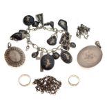 Eastern white metal charm bracelet of curb link design set with sixteen assorted niello charms,