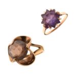 Two yellow metal dress rings, one with amethyst-coloured purple stone, the other brown topaz-