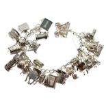 White metal charm bracelet of curb link design set with approximately thirty-two silver and white