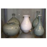 Four Korean celadon glazed vases decorated with cranes, and one other similar white glazed vase, the