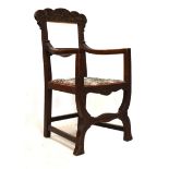 20th Century heavily carved oak open arm elbow chair