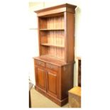 Late 19th/early 20th Century beech two section bookcase, the base fitted two doors, 107cm wide