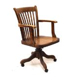 Early 20th Century oak swivel desk armchair, the rear of the seat with metal plate stamped 4 4/3998