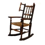 19th Century ash framed child's rocking armchair having rush seat, overall height 82cm