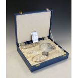 Cased Queen Elizabeth II silver backed dressing set comprising mirror and two brushes, all with