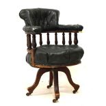 Late 19th/early 20th Century walnut framed swivel office tub chair upholstered in green faux leather