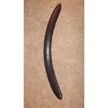 A 19th century wooden boomerang with con