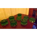 Eight green glass carpet protectors in m