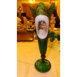 A large pedestal green glass vase with p