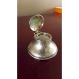 A small silver covered desk inkwell with
