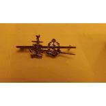 An unusual gold bar brooch marked 9ct wi