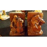 A pair of carved wooden bookends depicti