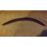 A 19th century hand-carved boomerang.
