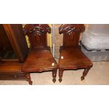 A pair of Victorian mahogany hall chairs