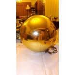 A 10 1/2" diameter gold witches' ball wi