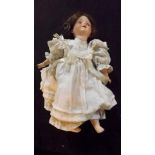 An antique porcelain faced doll marked "