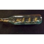 A vintage glass bottle 12" long containi