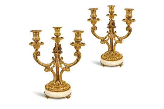 A pair of gilt bronze three arm candelabras