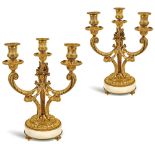 A pair of gilt bronze three arm candelabras