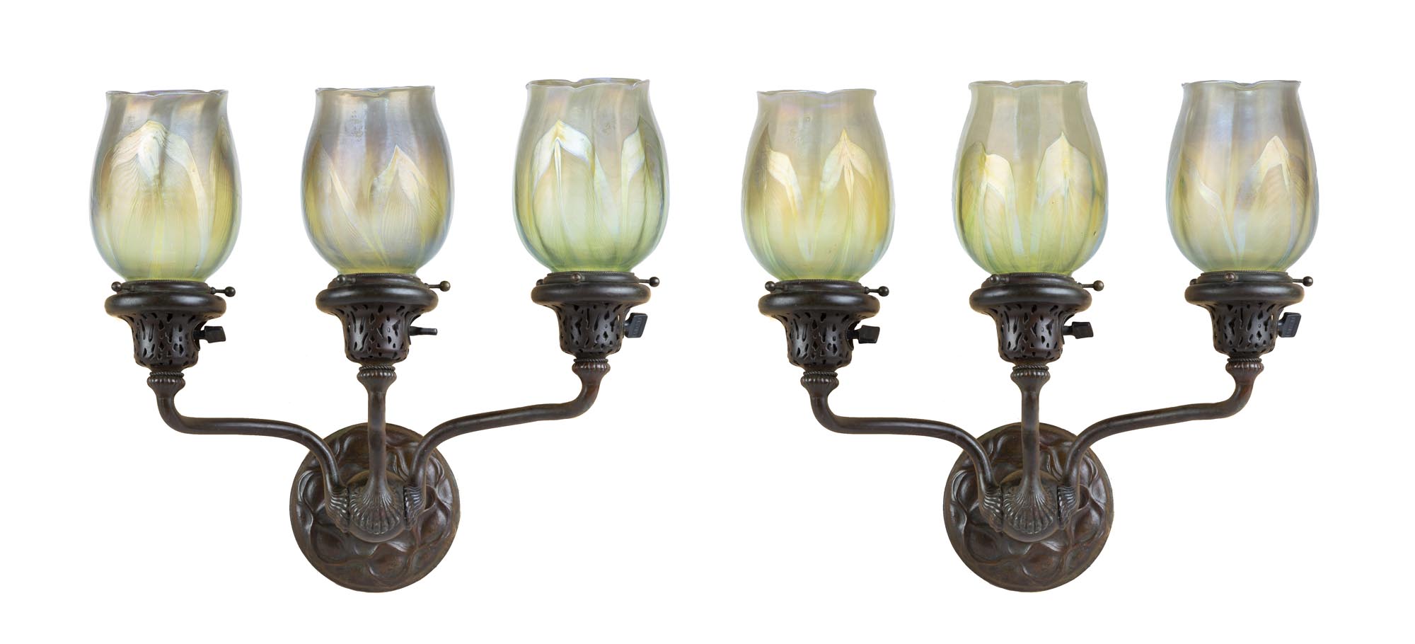 Pair of Tiffany Studios, New York, Three Arm Sconces. Early 20th century. Brown patina. Shades are