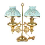 Double Brass Student Lamp with Griffins. Early 20th century. Period blue cased ribbed shades, hand