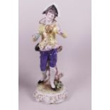 A Naples porcelain figurine of a young boy with a bunch of grapes, 11" high