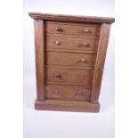 A small C19th mahogany collector's Wellington chest of five graduated drawers with locking bar and